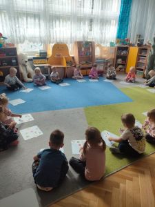 Dzieci układają obrazki z warzywami na podkładce przed sobą