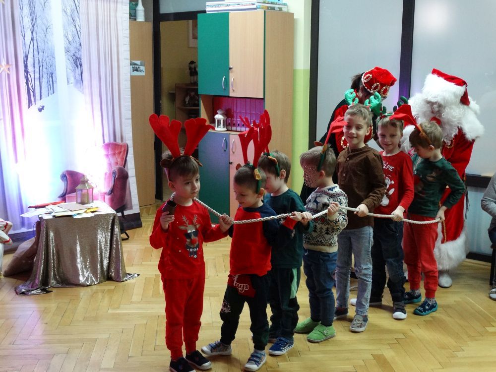 7 chłopców udaje renifery w zaprzęgu świętego Mikołaja