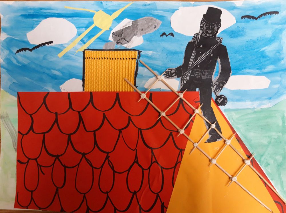 Praca plastyczna przedstawiająca kominiarza siedzącego na dachu domu